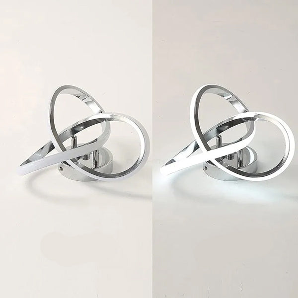 Plafonnier LED argenté anneaux croisés luminaire géométrique moderne